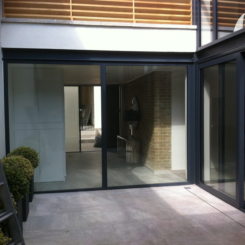Floor-to-ceiling sliding doors opening to courtyard in Wandsworth