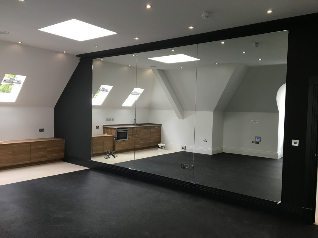 Frameless glass wall dividing loft conversion in Wandsworth