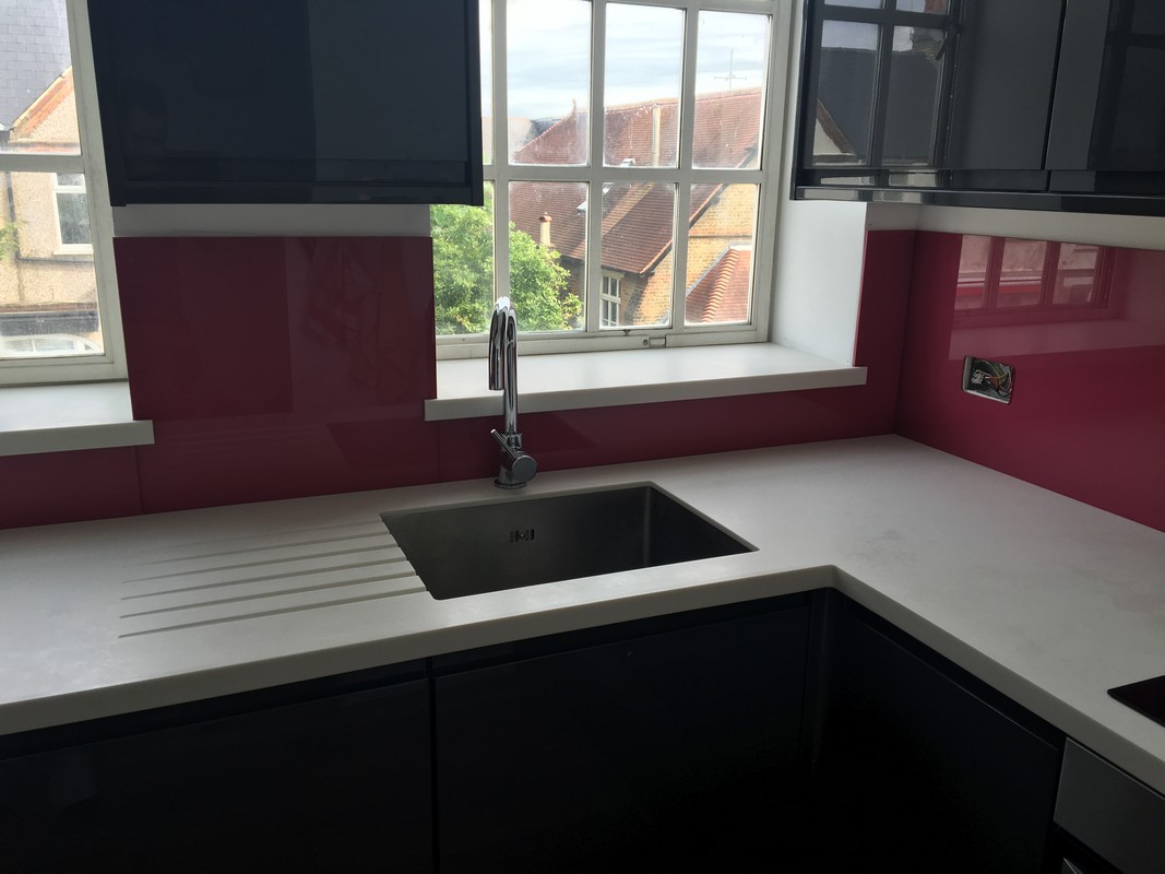 Deep plum coloured glass splashback in modern Wandsworth kitchen